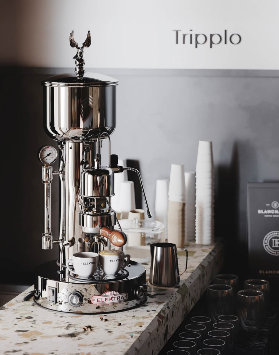 Tripplo coffee machine on a counter with 'Blancpain' branding in the background