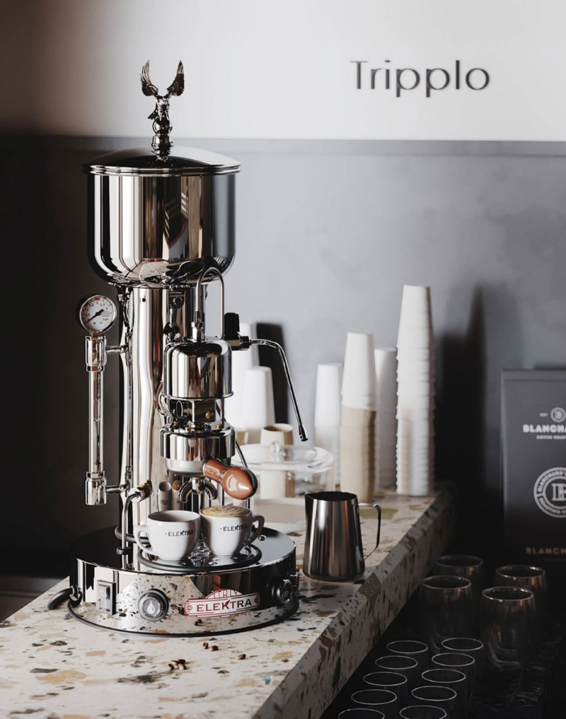 Tripplo coffee machine on a counter with 'Blancpain' branding in the background